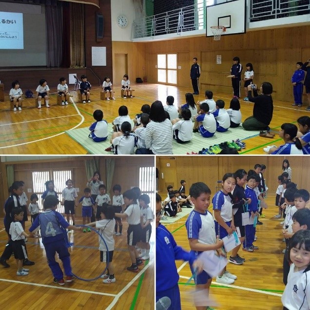 体操着姿の新入生と児童たちが体育館でゲームをして交流している写真