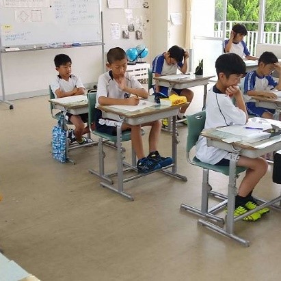 頭やあごに手を当てて悩んでいる児童たちの写真