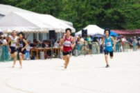 グラウンドで全力疾走している男子児童の写真