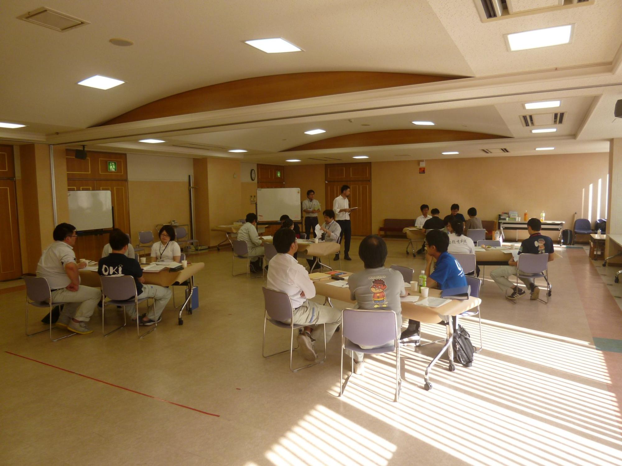 小人数のテーブルに分かれて意見交換を行っている職員たちの写真