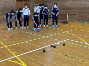体育館でボッチャを楽しむジャージ姿の生徒たちの写真