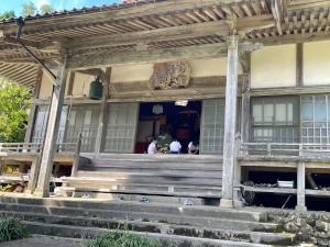 寺の本堂でお参りをする児童たちの写真