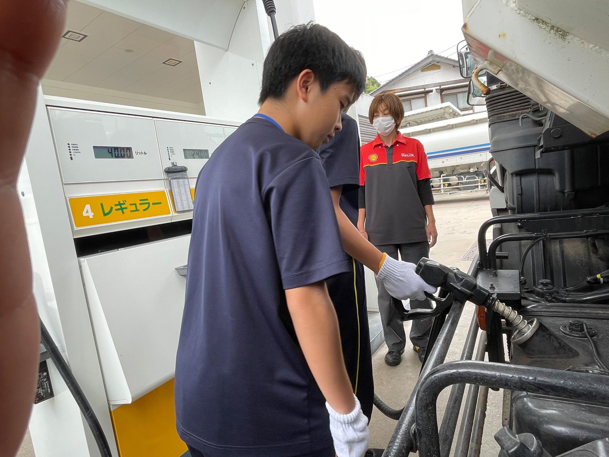 職場体験で生徒がガソリンスタンド業務を体験する写真