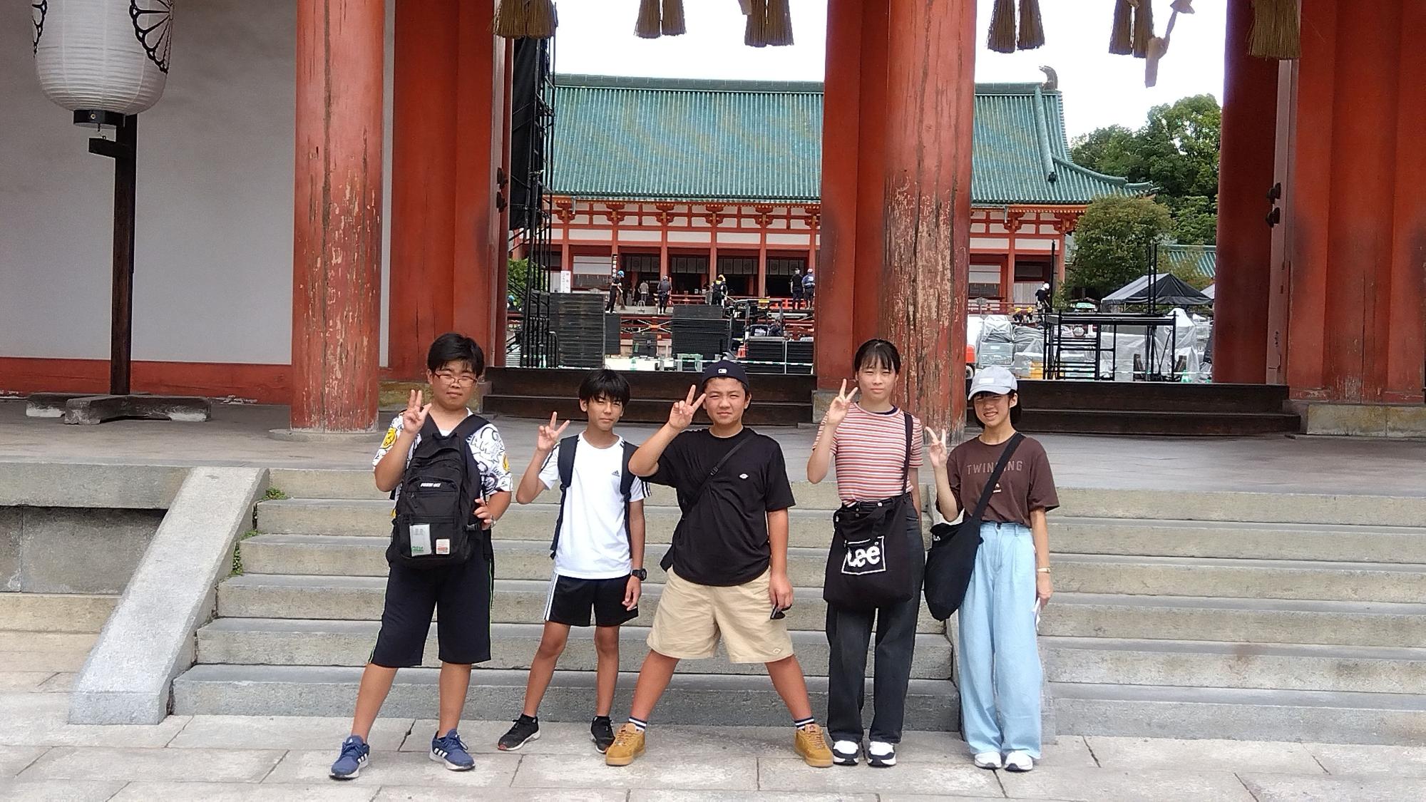 京都の寺院前で生徒たちが記念撮影をする写真