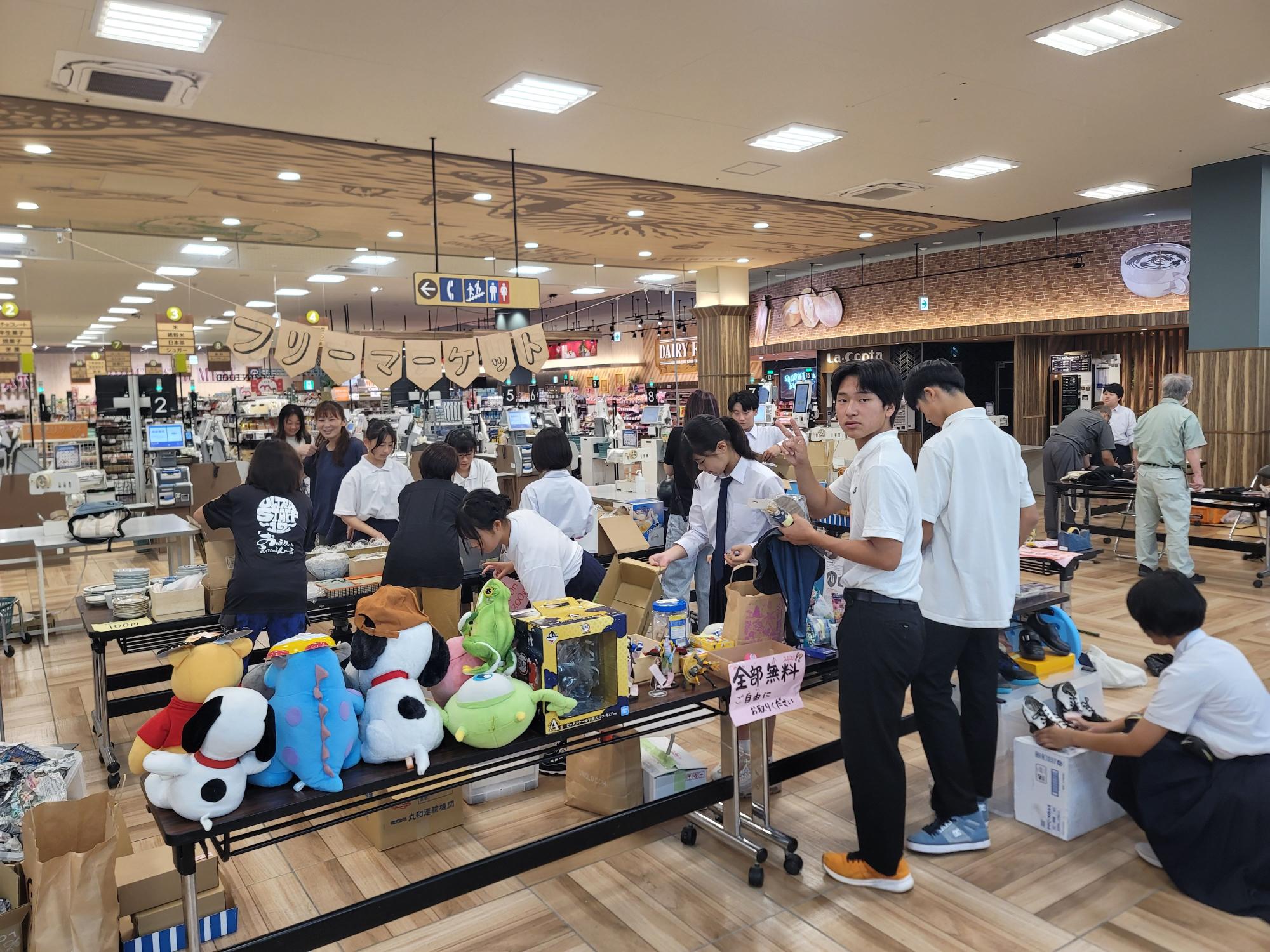 商業施設内でフリーマーケットの準備をする生徒たちの写真