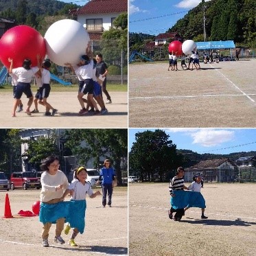 運動場で児童たちが紅白の大玉を持ち上げたり、大きなパンツに片足ずつに一人一人で入り走っている複数の写真