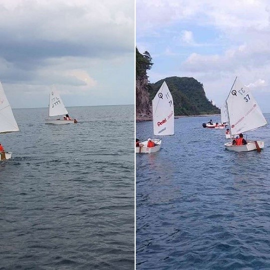 ライフジャケットを着た児童たちが海上でヨットに乗っている写真