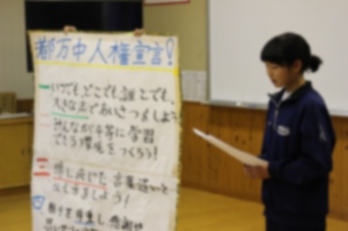模造紙に書かれた学校独自の人権宣言を読み上げる生徒の写真